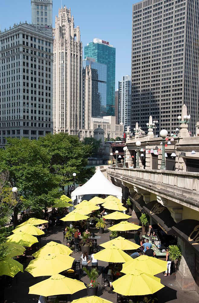 Yellow umbrellas at cafe at Riverwalk along the Chicago River in downtown Chicago